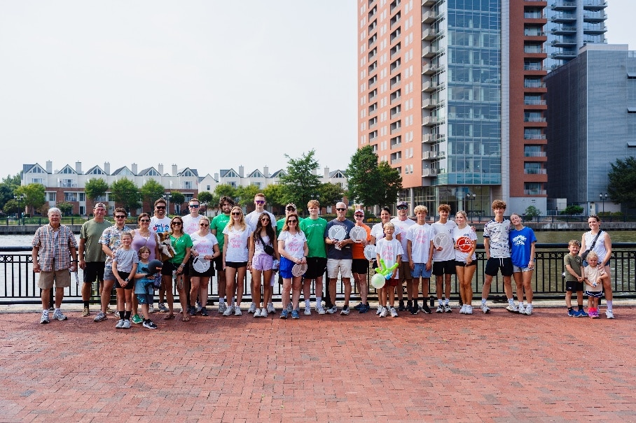 Team poses for a photo by the Wilmington Riverfront at the Delaware ALS United Walk.