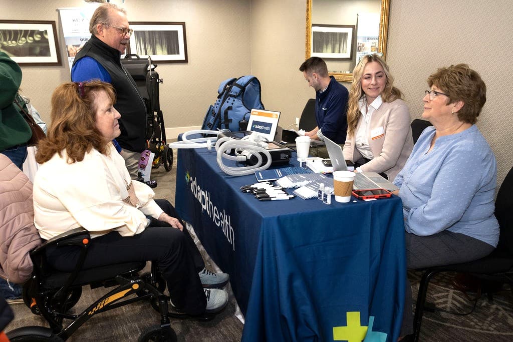 Participants of the 2026 Help and Hope Symposium chat with vendors.